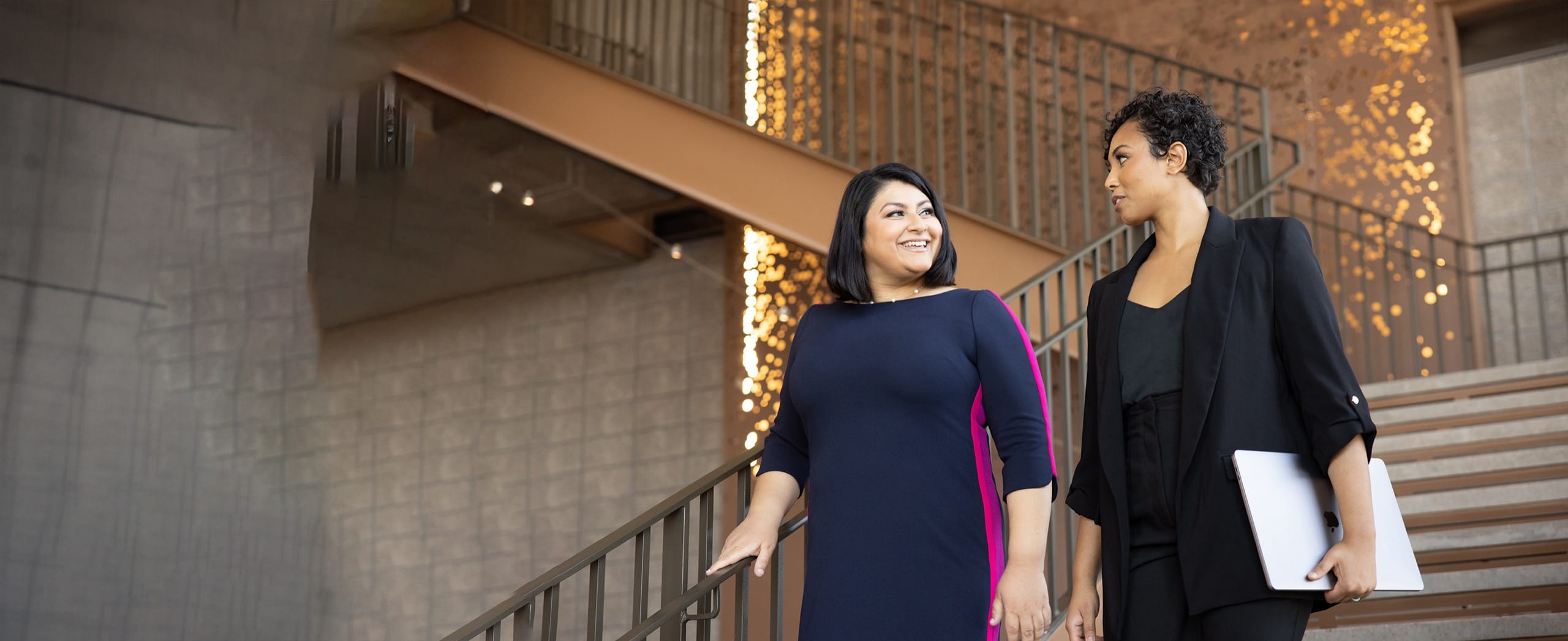 Women educators walking down stairs