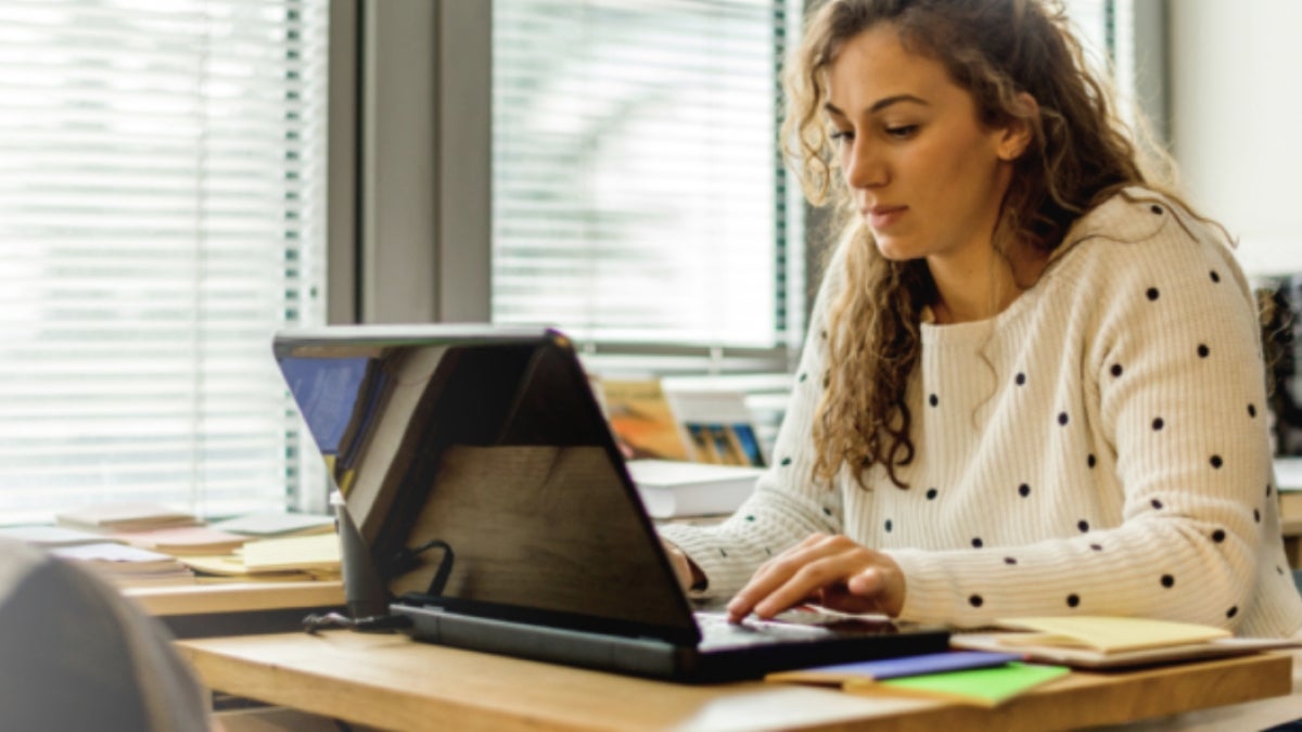 Women sitting at desk with laptop