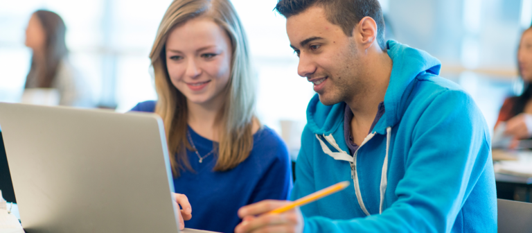 a man and a woman explore online learning on a computer